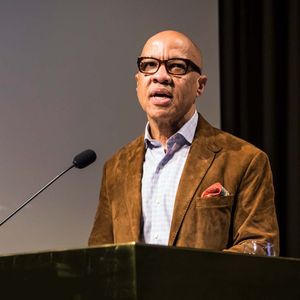 Ford Foundation president Darren Walker speaking at a podium on stage