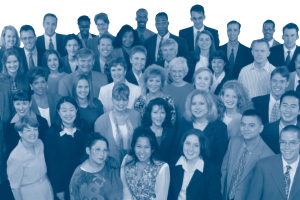 A group portrait of a large, diverse group of smiling people. The image is filtered in blue tones, showing the faces and shoulders of men and women, appearing as a professional team or organization.