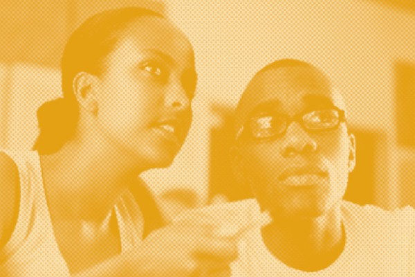 A sepia-toned, halftone image of a man and a woman in conversation. The woman gestures with her hand, and the man with glasses looks up, listening intently.