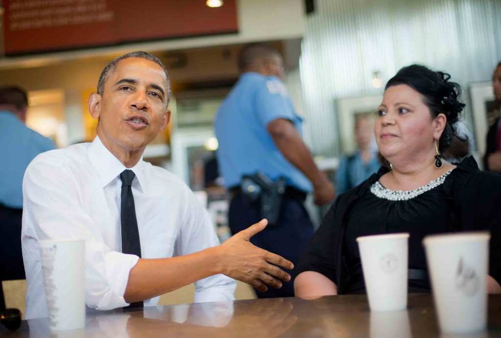 Barack Obama sits down with Shelby Ramirez, speaking and gesturing with his hands.