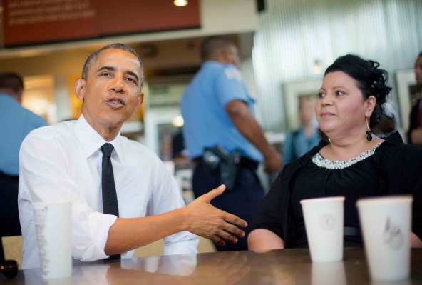 Barack Obama sits down with Shelby Ramirez, speaking and gesturing with his hands. 