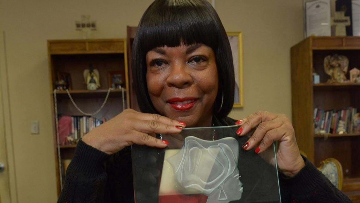 Dorothy Johnson-Speight poses with an award. 