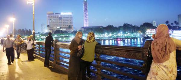 Egyptians walking on a promenade overlooking the Nile in downtown Cairo.