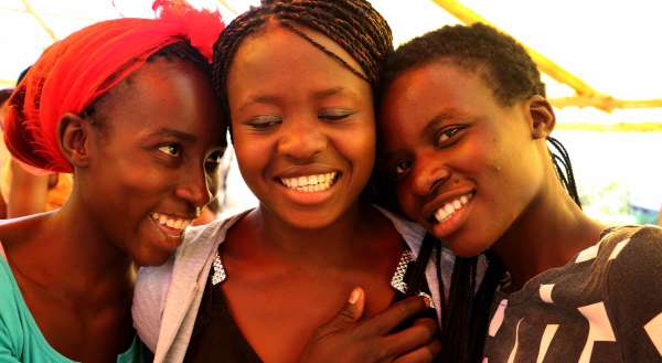 Three young women laughing together