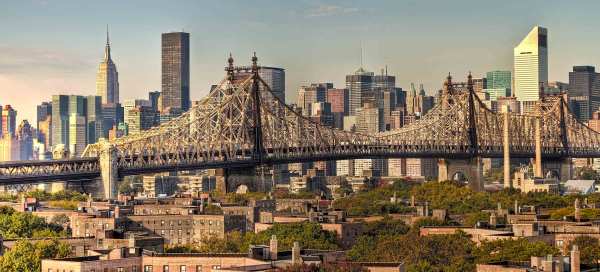 The New York City skyline with a bridge in the foreground and skyscrapers in the background.