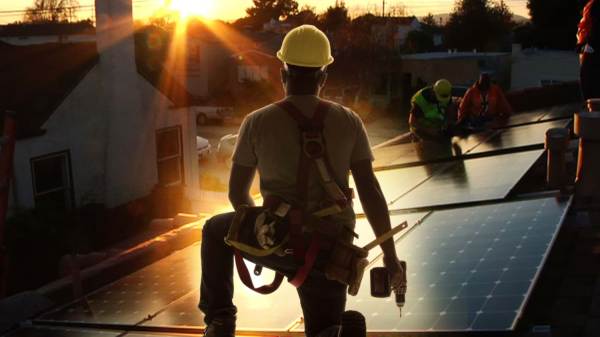 Workers installing solar panels.