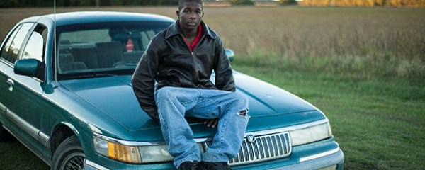 Young man sitting on car hood in rural North Carolina. This image is unavailable under the 4.0 Creative Commons license.