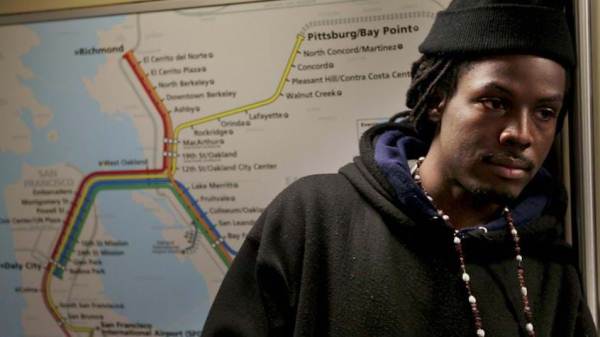Young man in front of a transit map. This image is unavailable under the 4.0 Creative Commons license.