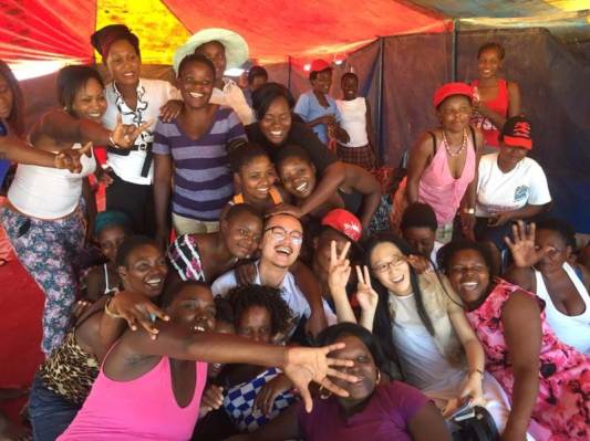 Smiling Ford Foundation grantees from China and Zimbabwe pose together in a friendly group.