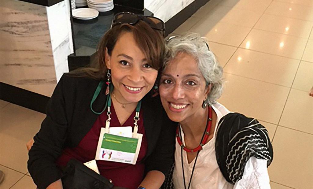 Kavita Ramdas poses with another attendee at the Association of Women's Rights in Development forum in Brazil.