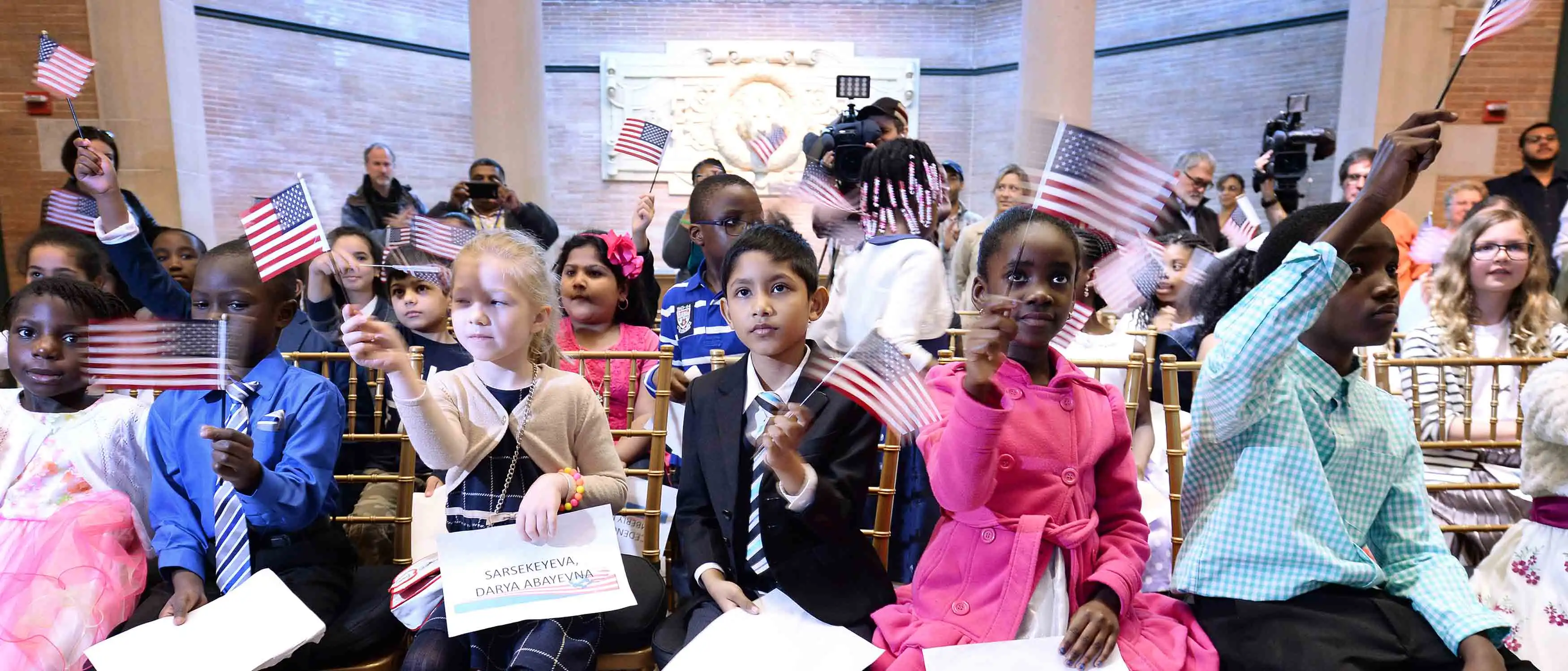 Children waving United States flags.