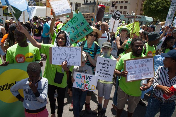 People are holding signs as they march at Keizergracht Street during a protest against 'Climate Change and Global Warming,' in Cape Town, South Africa. Credit: Anadolu Agency