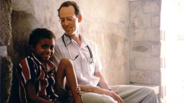 Doctor smiling with young Haitian patient