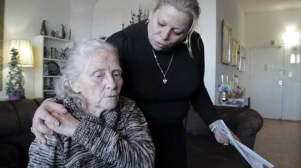 Home care worker comforting senior