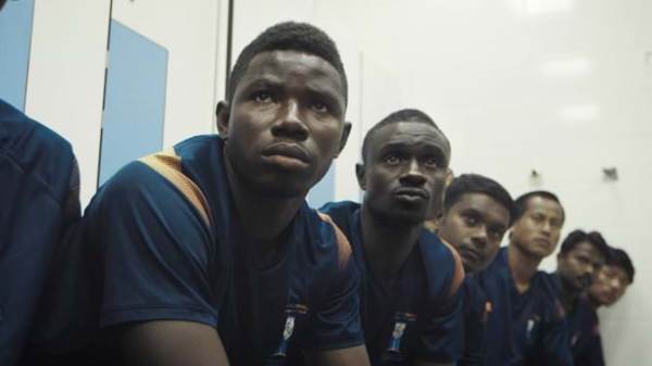 Group of football players staring off.