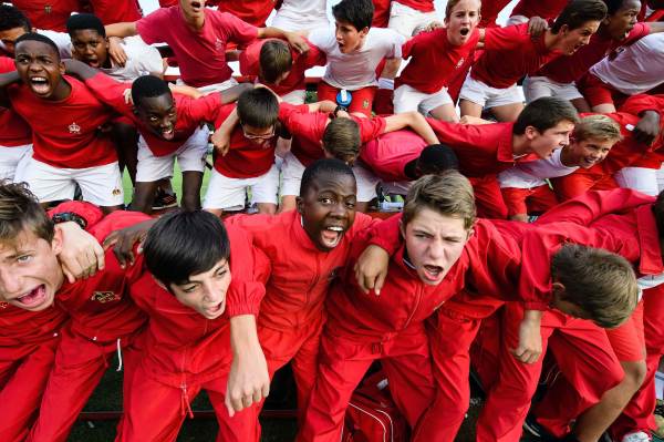 Students at the King Edward VII school take part in the traditional 'War Cry' ahead of an inter-school rugby match in Johannesburg (Photo by Leon Neal/Getty Images)
