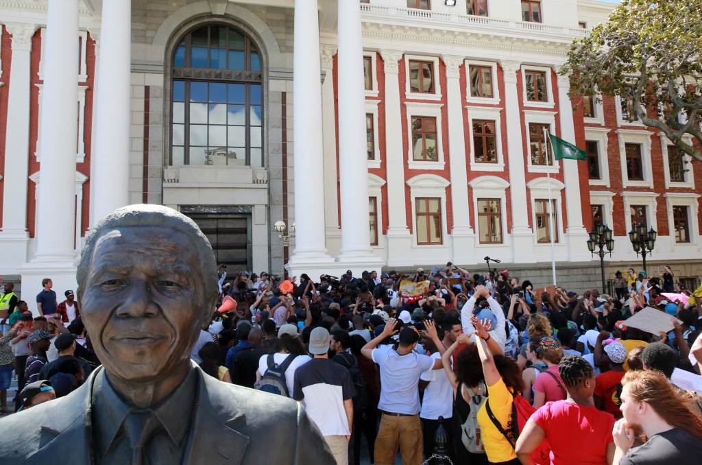 Protesting students broke through the gates of parliament during protests against a proposed hike in tuition fees.