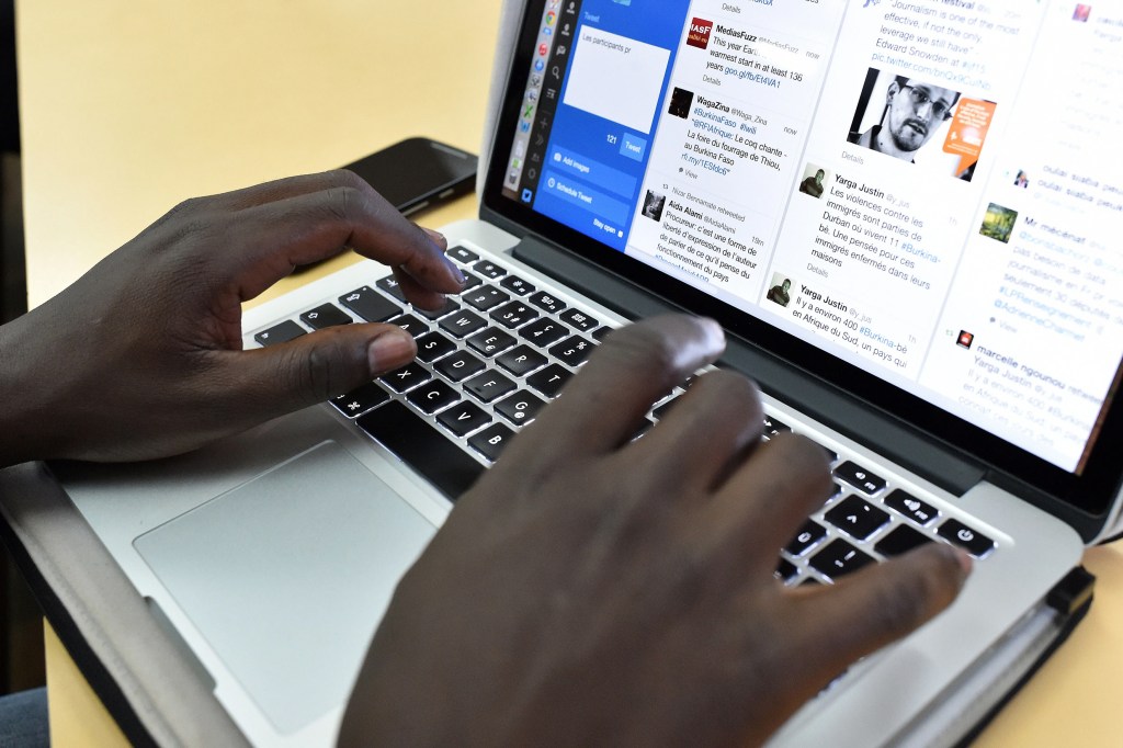 Individual checking their Twitter account on a laptop.