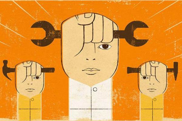 Evocative illustration of head-like fists holding hand tools