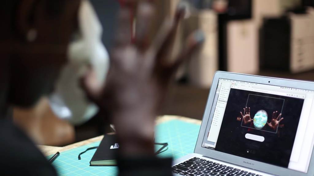 Laptop user with facial recognition software on their screen