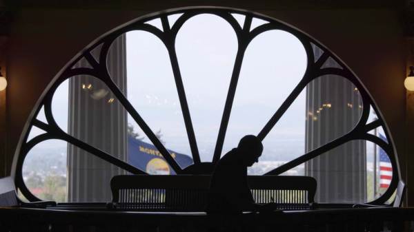 Dark figure silhouetted in window