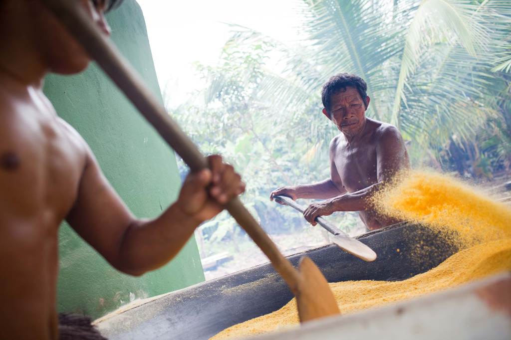 Joaqrum Sampaio works at the Manioc grinding building, near Rio Preta da Eva in Amazonas, Brazil.