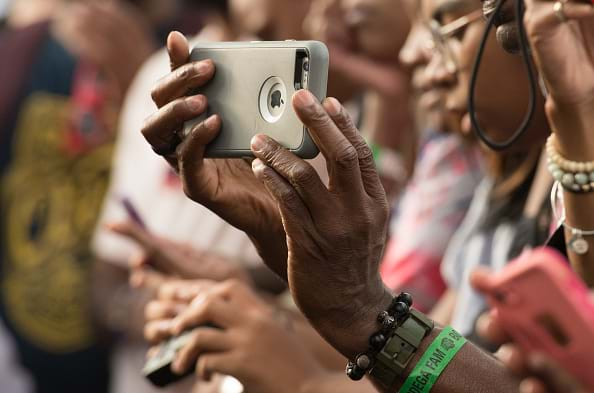 Group of people using their smart devices to take pictures