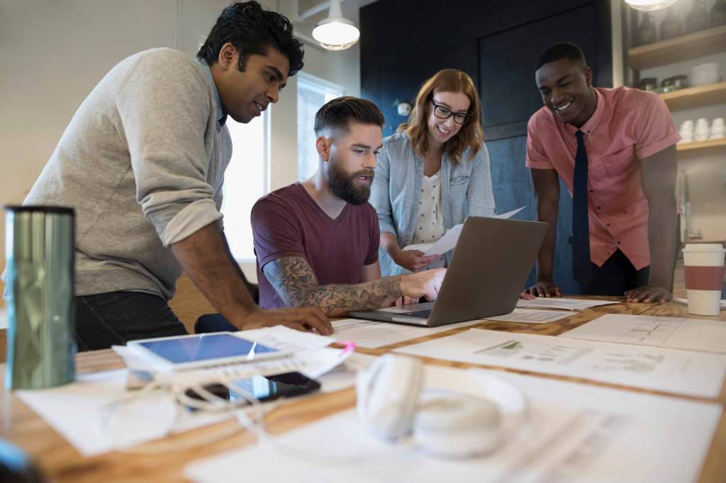 Colleagues collaborate: Bringing multiple tech fellows into an organization at once can enable peer support and shared learning.