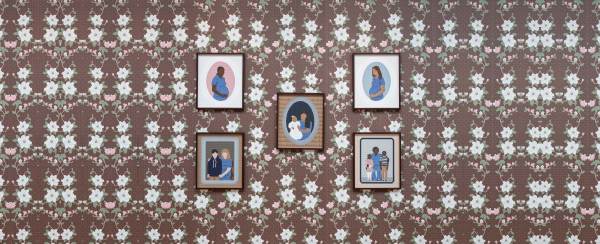 Five framed images hanging on a flower print wall.