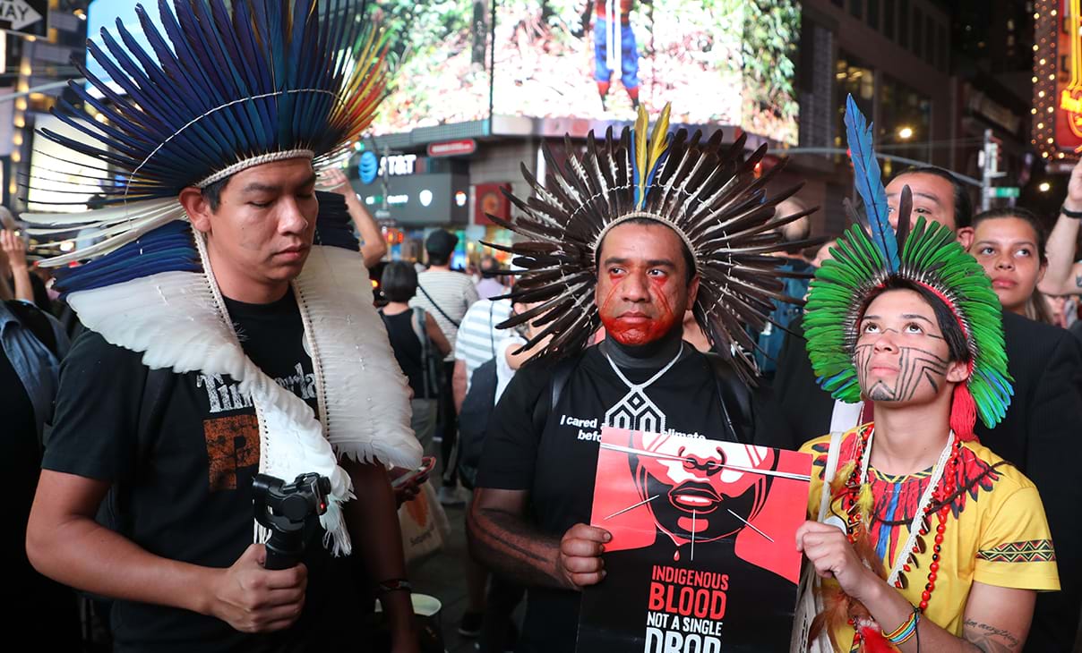 Eric Terena (L), Dinamam Tuxa (C) and Artemisa Xakriaba demonstrate in Times Square.