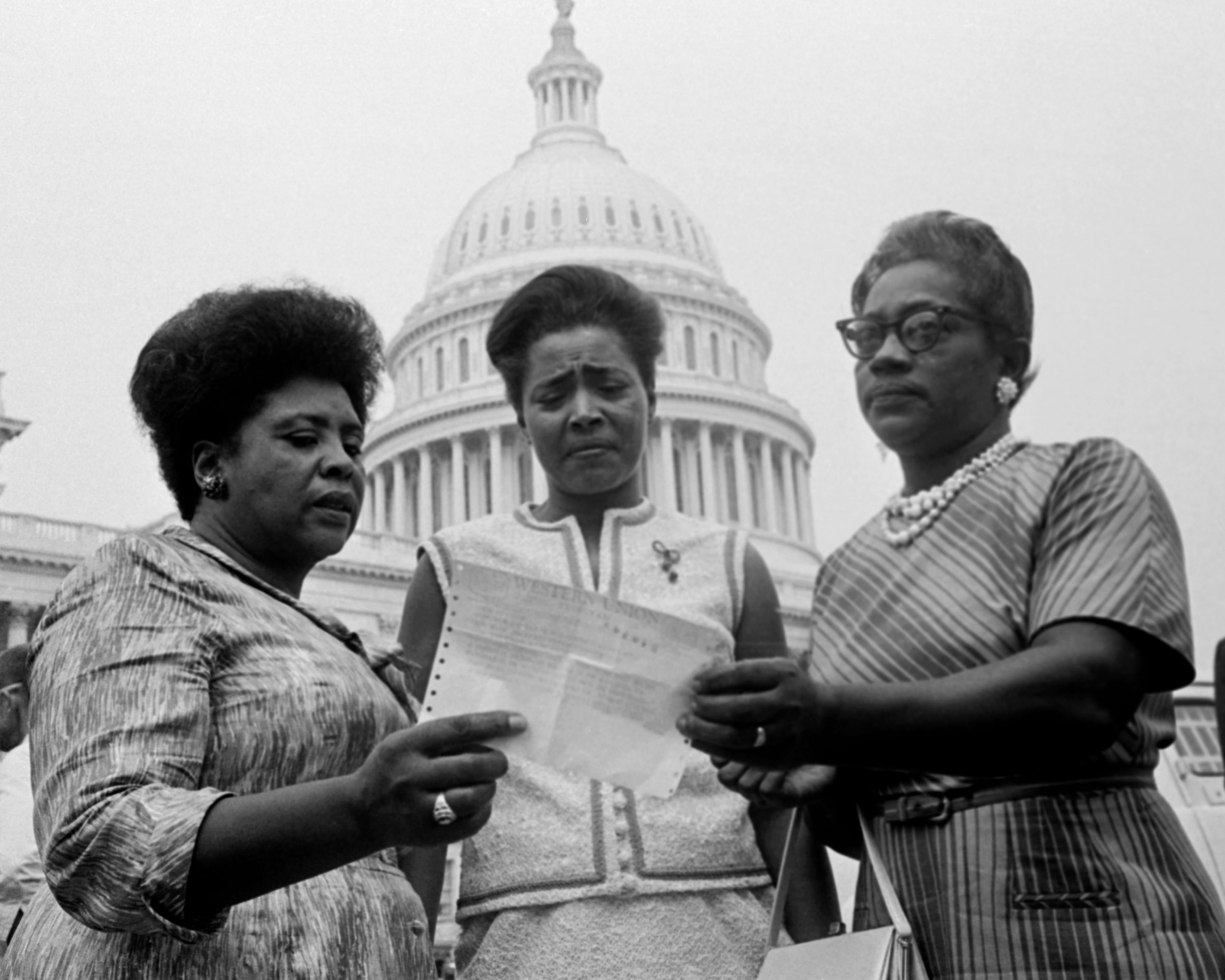 Three members of the Mississippi Freedom Democratic Party's contestants for the state's five seats hold a telegram from Speaker John McCormick granting them permission to take seats on the House floor during the debate.