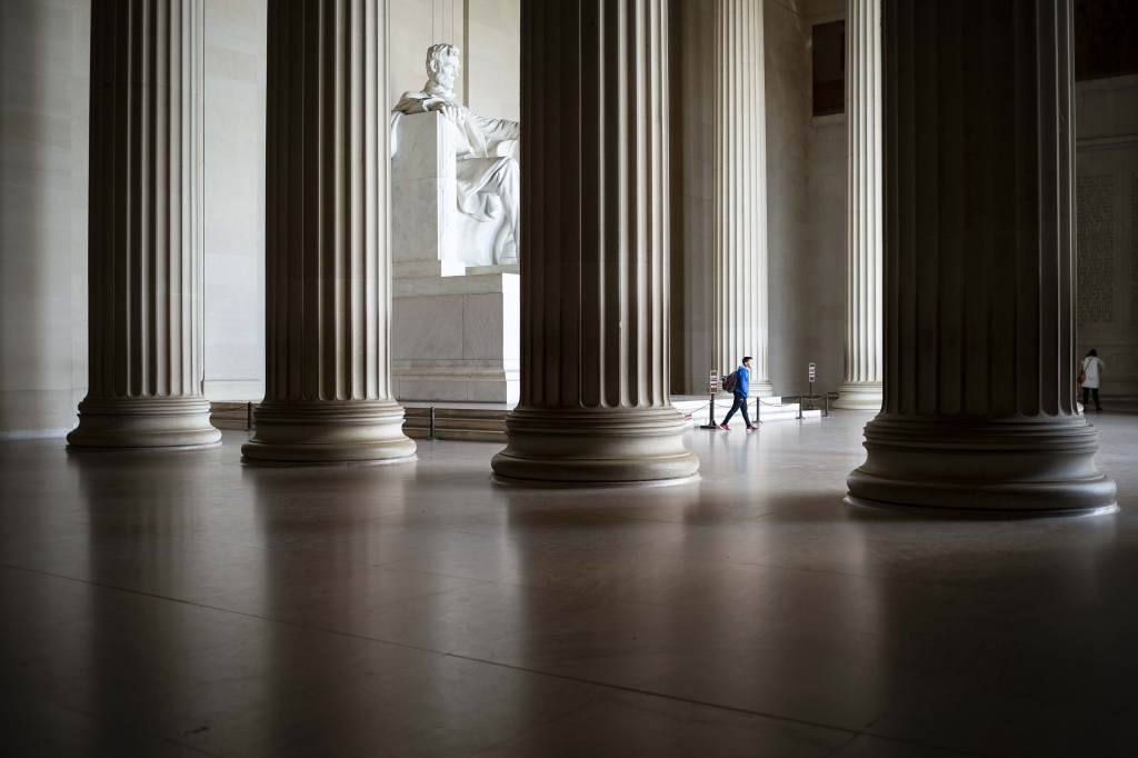 A person walking through the Lincoln Memorial in Washington D.C.