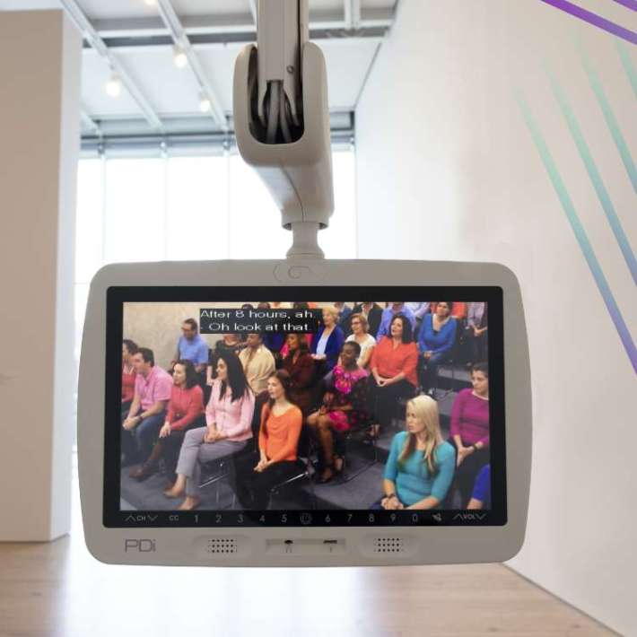 A smooth, white television monitor attached to a robotic arm extends into an empty art gallery and plays a daytime talk show. Caption reads: "After 8 hours, ah" and "Oh look at that."