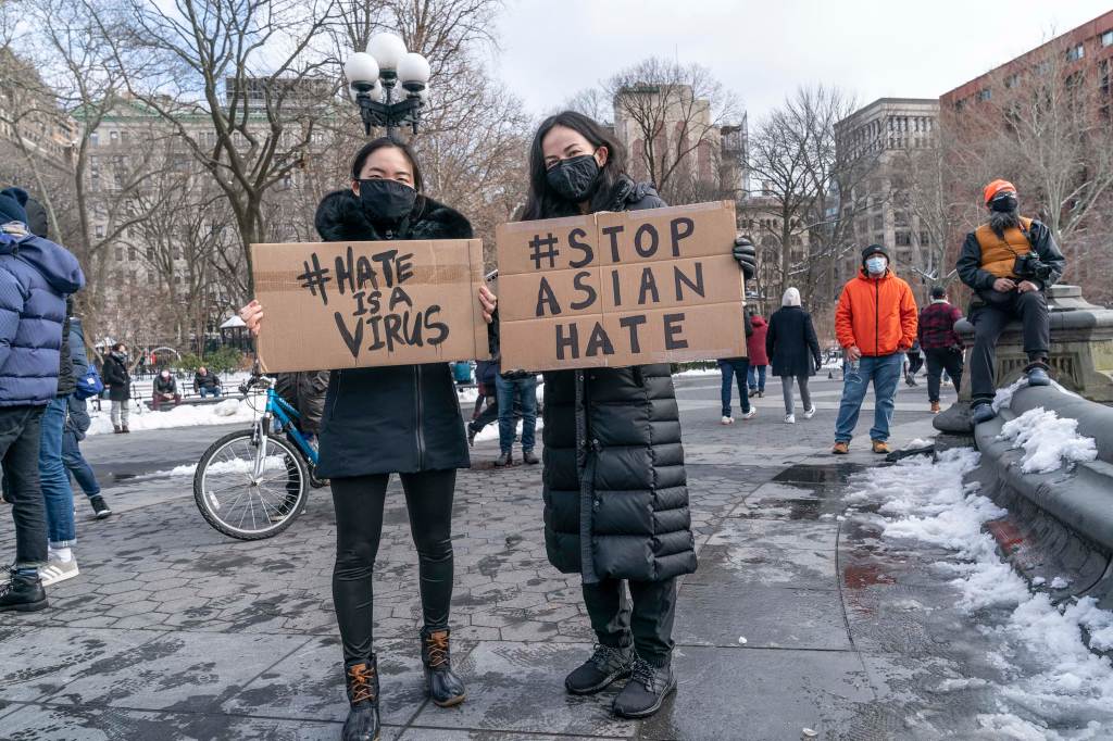 Protestors hold signs that read "hate is a virus" and "stop Asian hate" at the End The Violence Towards Asians rally in Washington Square Park. Photo by Dia Dipasupil/Getty Images