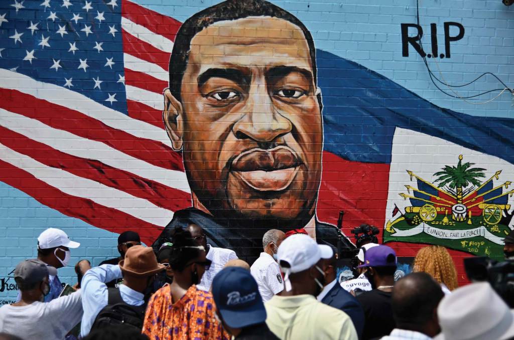 People gather at the unveiling of artist Kenny Altidor's memorial mural of George Floyd in Brooklyn, New York.