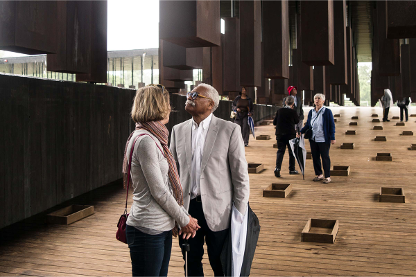 Visitors walk through an exhibit at the National Memorial for Peace and Justice  in Montgomery, Alabama.