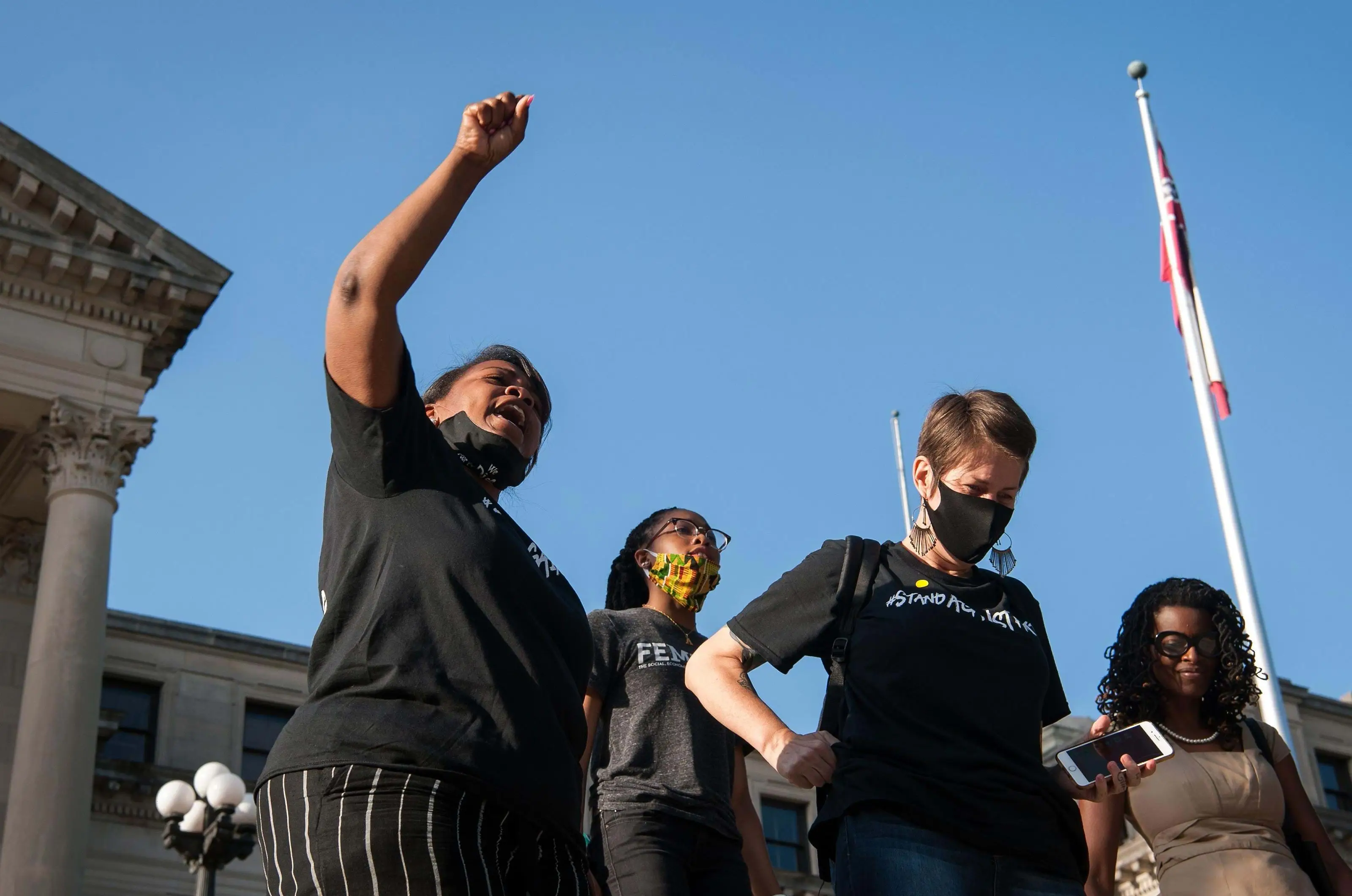 Protesters celebrate the state legislature's historic vote to change the Mississippi flag at the Mississippi State Capitol building in Jackson, Mississippi.