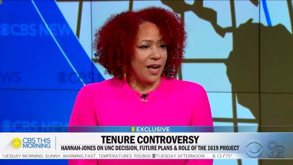 Nikole Hannah-Jones wearing a fuschia colored dress on the set of CBS This Morning.