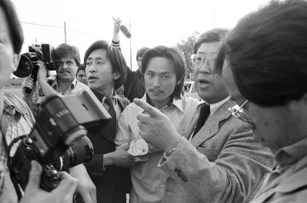 black and white image of Chol Soo Lee being taken into police custody