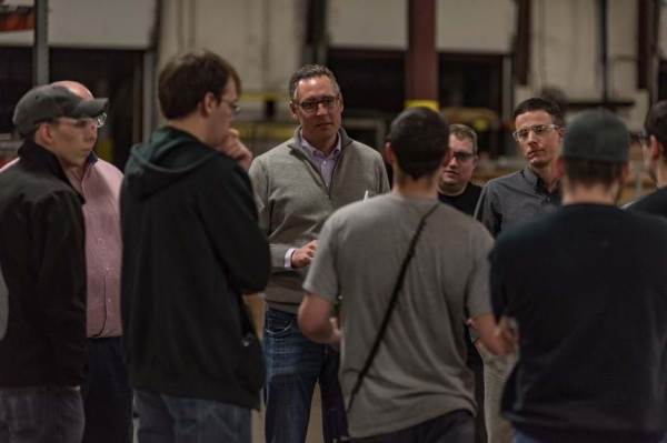 Ownership Works is the brainchild of Pete Stavros, co-head of private equity for the Americas at KKR, shown in a gray sweater with CHI Overhead Doors workers in 2018.