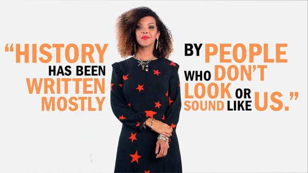 Phoebe Boswell has shoulder-length dark curly hair with highlights and is wearing silver earrings, necklaces, and black and white beaded bracelets. She has on a black dress with red stars. She's standing between copy that read, "History has been written mostly by people who don't look or sound like us."