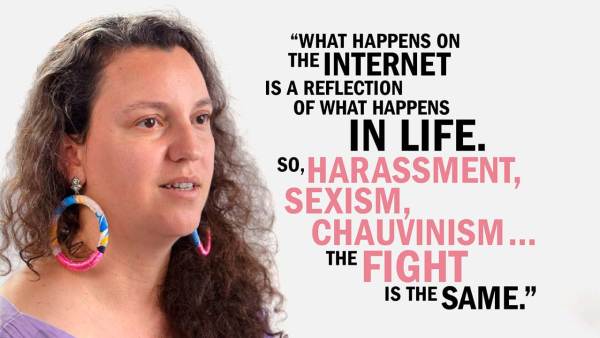 Steffania Costa has long brown curly hair and is wearing colorful looped earrings and a violet top. She's next to copy that reads, "What happens on the internet is a reflection of what happens in life. So harassment, sexism, chauvinism... the fight is the same."