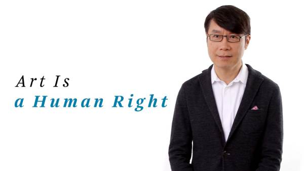 Samuel Hoi wears a black blazer over a white button-down shirt. The phrase "Art Is a Human Right" appears to the left.