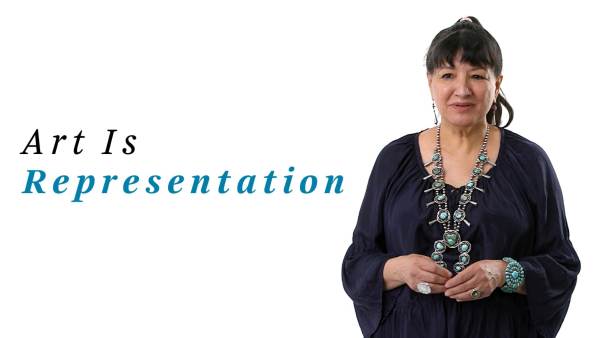 Sandra Cisneros wears a black long-sleeved dress and ornate silver and turquoise necklace, bracelet, and rings. The phrase "Art Is representation" appears to the right.