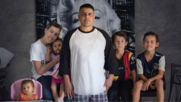 A photograph of Elizabeth and Marcos Perez and their four children.