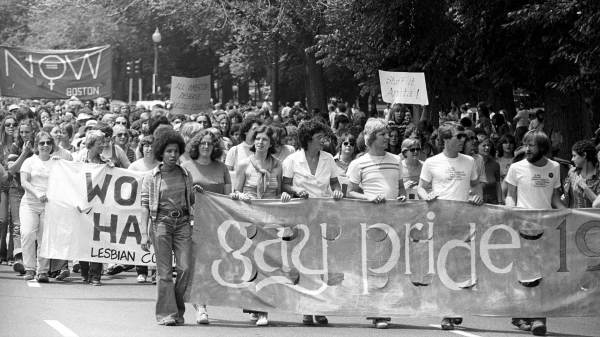 A large group of demonstrators participating in a gay and lesbian pride parade.