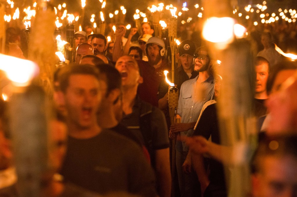 White nationalists and supremacists and neo Nazis carrying torches, surrounded and taunted counter protestors in Charlottesville.