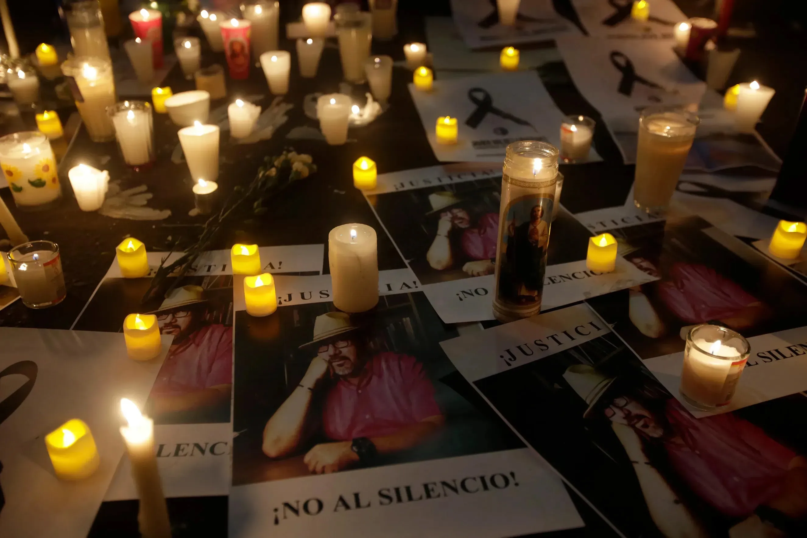 Signs and candles set on the ground for the remembrance of Mexican journalist Javier Valdez.
