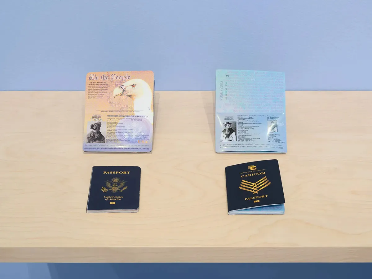Four passports on a desk. The top two passports are open while the bottom two are closed.
