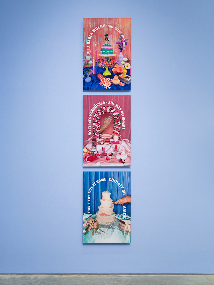 Three digital photo prints vertically hung on a light blue wall displaying colorful dessert shrines with Spanish and English text.